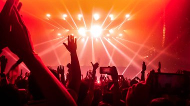Happy people dance in nightclub DJ party concert and listen to electronic dancing music from DJ on the stage. Silhouette cheerful crowd celebrate New Year party 2020. People lifestyle DJ nightlife. clipart