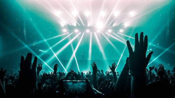 Счастливые люди танцуют в ночном клубе DJ party концерт и слушают электронную танцевальную музыку от DJ на сцене. Силуэт веселая толпа празднует Новый год 2020. DJ nightlife
.