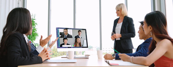 Video call group business people meeting on virtual workplace or remote office. Telework conference call using smart video technology to communicate colleague in professional corporate business.