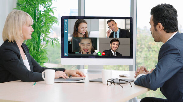 Video call group business people meeting on virtual workplace or remote office. Telework conference call using smart video technology to communicate colleague in professional corporate business.