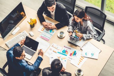 İş adamları grup toplantısı ofiste yukarıdan çekildi. İş kadınları, iş adamları ve ofis çalışanları, proje planlama belgeleriyle takım konferansında toplantı masasında çalışıyorlar. .
