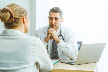 Profesyonel üniformalı doktor hastanedeki ya da klinikteki hastayı muayene ediyor. Sağlık, sağlık ve doktor hizmetleri konsepti.