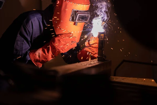 Metal welding steel works using electric arc welding machine to weld steel at factory. Metalwork manufacturing and construction maintenance service by manual skill labor concept.