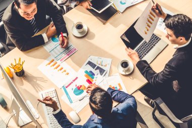 İş adamları grup toplantısı ofiste yukarıdan çekildi. İş kadınları, iş adamları ve ofis çalışanları, proje planlama belgeleriyle takım konferansında toplantı masasında çalışıyorlar. .