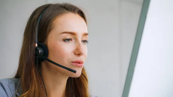 Business people wearing headset working in office to support remote customer or colleague. Call center, telemarketing, customer support agent provide service on telephone video conference call.