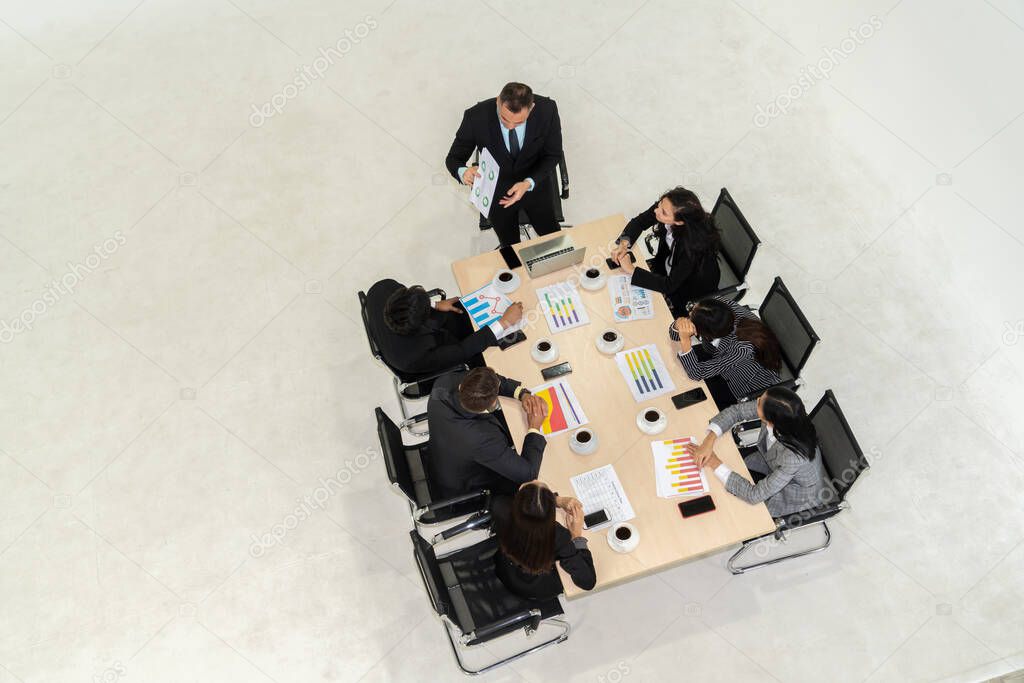 Business people group meeting shot from top view in office . Profession businesswomen, businessmen and office workers working in team conference with project planning document on meeting table .