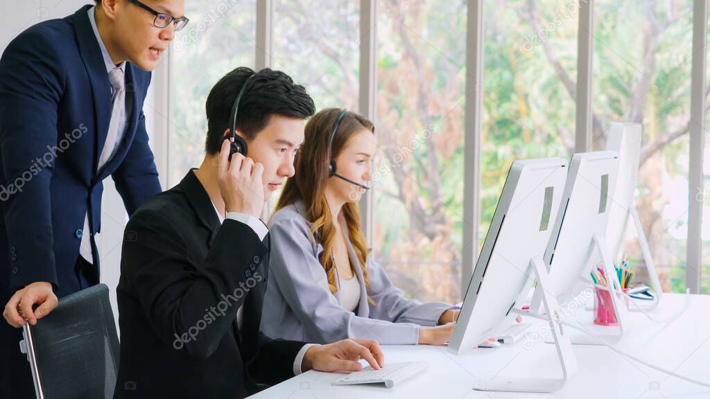 Business people wearing headset working in office to support remote customer or colleague. Call center, telemarketing, customer support agent provide service on telephone video conference call.
