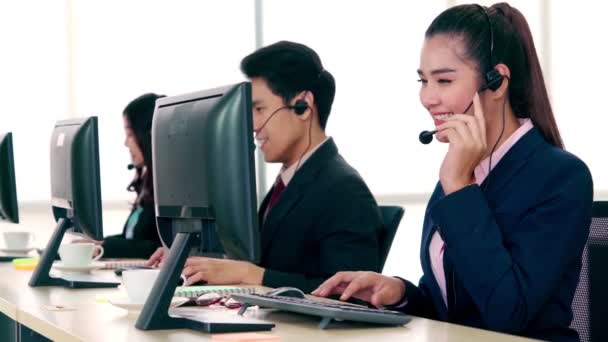 Liikemiehet käyttävät toimistossa toimivia kuulokkeita — kuvapankkivideo