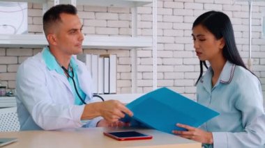 Profesyonel üniformalı doktor hastanedeki hastayı muayene ediyor.