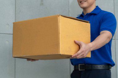 Paket kutusunu müşteriye göndermek için taşıyan teslimatçı. Teslimat işi konsepti .