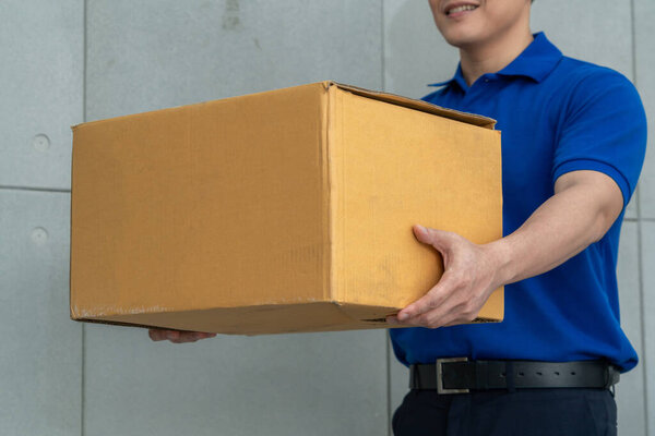 Delivery person carrying parcel box to send to customer . Delivery business concept .