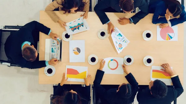 Business people group meeting shot from top view in office . Profession businesswomen, businessmen and office workers working in team conference with project planning document on meeting table .