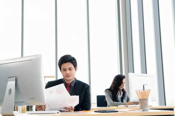 Business people working at table in modern office