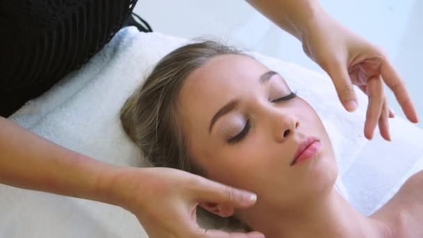 Frau bekommt Gesichts- und Kopfmassage im Luxus-Spa. — Stockvideo