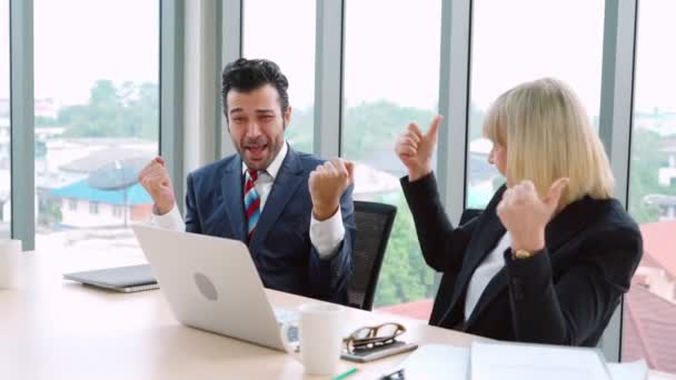 Two happy business people celebrate at office — Stock Video