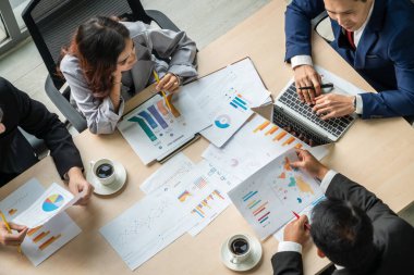 İş adamları grup toplantısı ofiste yukarıdan çekildi. İş kadınları, iş adamları ve ofis çalışanları, proje planlama belgeleriyle takım konferansında toplantı masasında çalışıyorlar. .