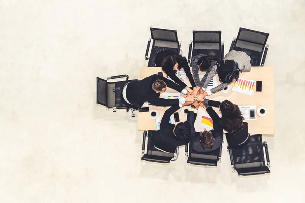 Happy business people celebrate teamwork success together with joy at office table shot from top view . Young businessman and businesswoman workers express cheerful victory showing unity and support .