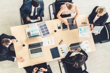 İş adamları grup toplantısı ofiste yukarıdan çekildi. İş kadınları, iş adamları ve ofis çalışanları, proje planlama belgeleriyle takım konferansında toplantı masasında çalışıyorlar. .