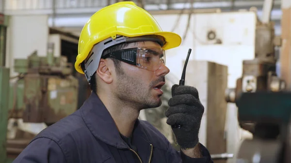 Factory Worker Talking Portable Radio While Inspecting Machinery Parts Industrial — Stock Photo, Image