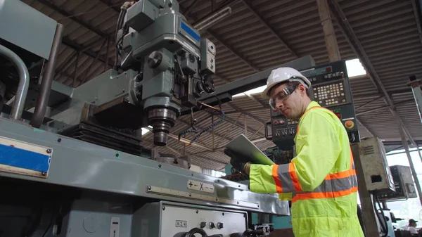 Smart factory worker using machine in factory workshop . Industry and engineering concept.