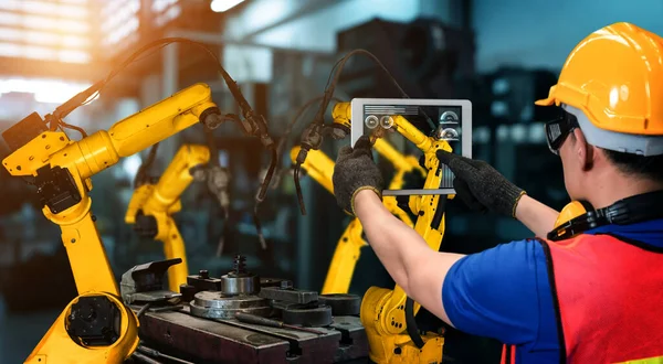 Smart industry robot arms for digital factory production technology showing automation manufacturing process of the Industry 4.0 or 4th industrial revolution and IOT software to control operation .