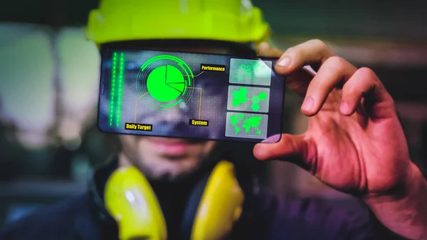 Factory worker use future holographic screen device to control manufacturing machine in factory . Concept of futuristic automation technology , virtual augmented reality and smart visualization .