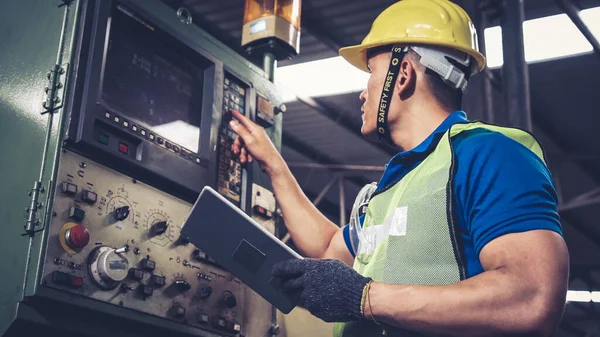 Smart factory worker using machine in factory workshop . Industry and engineering concept.