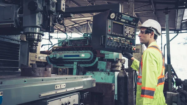 Smart factory worker using machine in factory workshop . Industry and engineering concept.