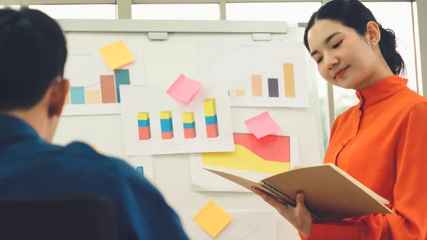 Young woman explains business data on white board — Stock Photo, Image