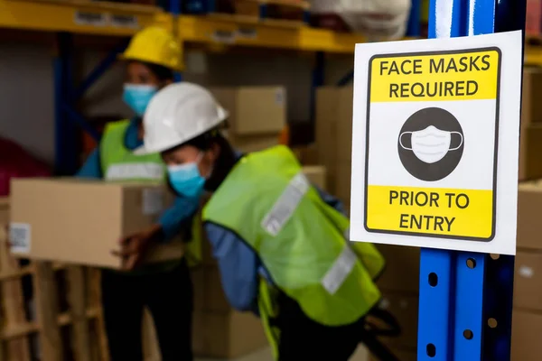 Caution sign in factory warning to industry labor worker to prevent Covid-19