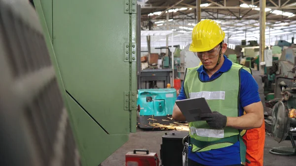 Smart factory worker using machine in factory workshop