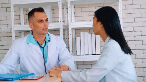 Doutor em uniforme profissional examinando paciente no hospital — Fotografia de Stock