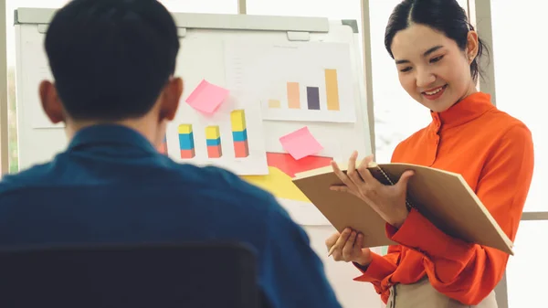 Young woman explains business data on white board — Stock Photo, Image