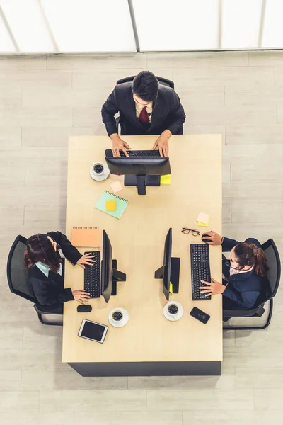 Business people wearing headset from top view in office working with computer