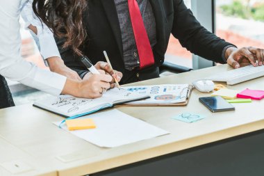 İki iş adamı ofiste proje stratejisi hakkında konuşuyor