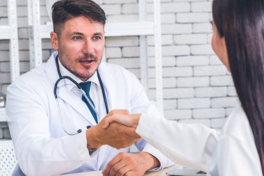 Profesyonel üniformalı doktor hastanedeki hastayı muayene ediyor.