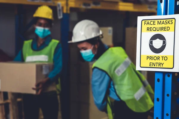 Caution sign in factory warning to industry labor worker to prevent Covid-19