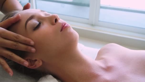 Mulher recebe massagem facial e na cabeça no spa de luxo. — Vídeo de Stock