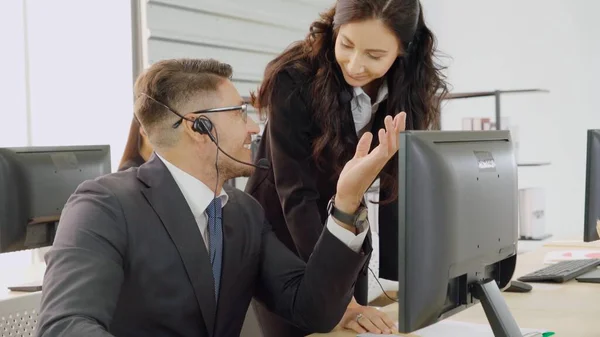 Zakenmensen met een koptelefoon aan het werk — Stockfoto