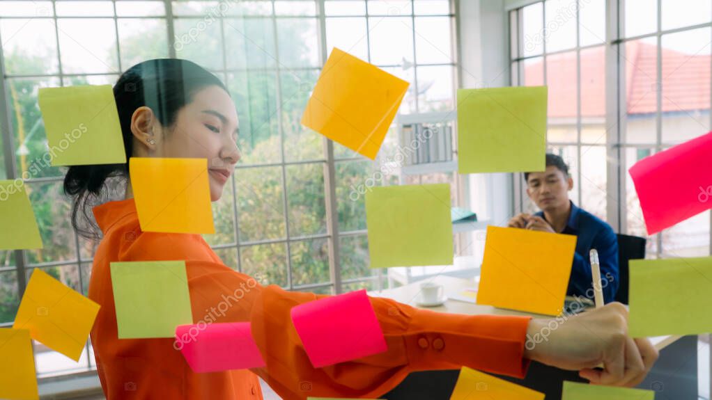 Business people work on project planning board