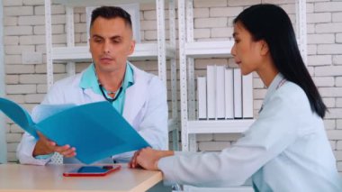 Profesyonel üniformalı doktor hastanedeki hastayı muayene ediyor.