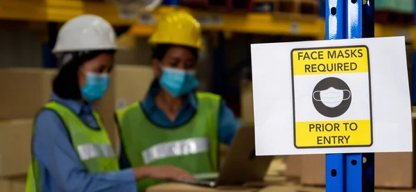 Caution sign in factory warning to industry labor worker to prevent Covid-19