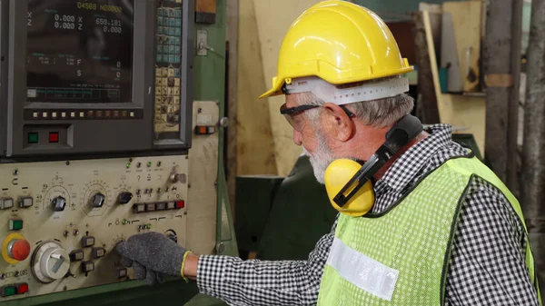 Smart factory worker using machine in factory workshop