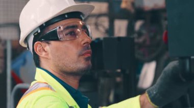 Fabrika atölyesinde makine kullanan akıllı bir fabrika işçisi