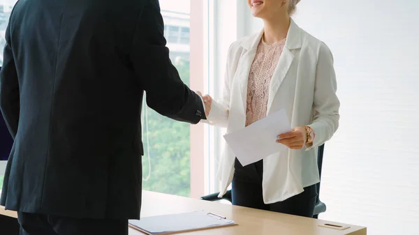 Job seeker and manager handshake in job interview