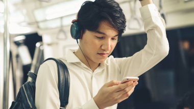 İş adamı trende cep telefonu kullanıyor.