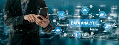 A business professional utilizes a smartphone to explore data analytics tools, highlighting the importance of data-driven strategies in today technology landscape. Tessel