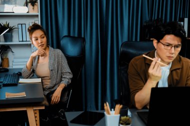 Stresli yüzü olan bir iş adamı dizüstü bilgisayarla e-posta beklerken aynı zamanda iş arkadaşı, modern ofiste gece yarısı danışmanlık işini tartışıyor ve şirket projesinde çalışıyor. İnfobahn.