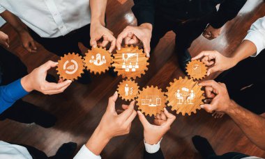 This image captures hands holding gears symbolizing collaboration in management. Perfect for visualizing teamwork, strategy, and growth in a business context. Amity
