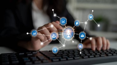 A business professional interacts with a keyboard displaying digital connectivity icons. This image symbolizes modern technology, data analysis, and healthcare solutions in the workplace. Tessel